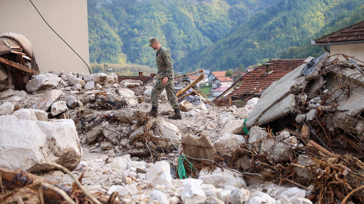 A Bosnian soldier inspects a damaged house after floods and landslides in the village of Donja Jablanica, Bosnia, on Oct. 5.