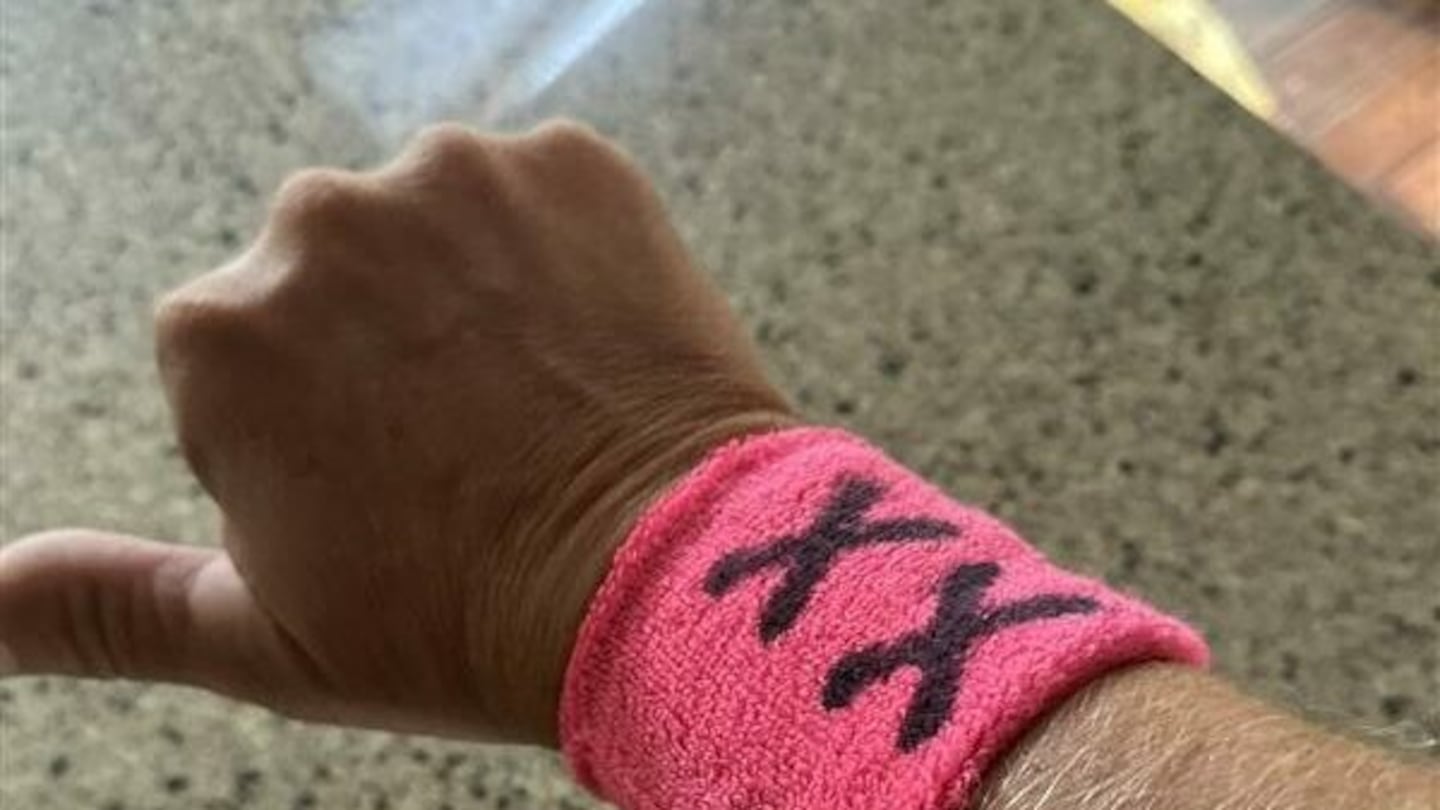 Parents wore pink "XX" wristbands at a soccer match in Bow, N.H., on Sept. 17 to protest the inclusion of transgender athletes in girls' school sports. School officials shut down the protest and issued "no trespass" orders, prompting a federal lawsuit.