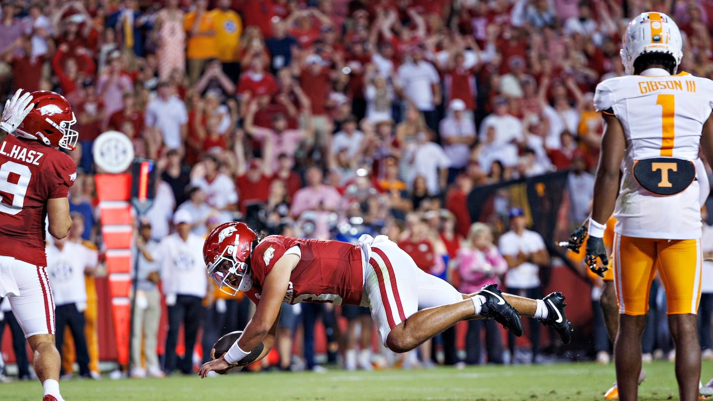 Quarterback Malachi Singleton dives into the end zone for the go-ahead touchdown, as Arkansas pulls off the upset of No. 4 Tennessee Saturday in Fayetteville, Ark.