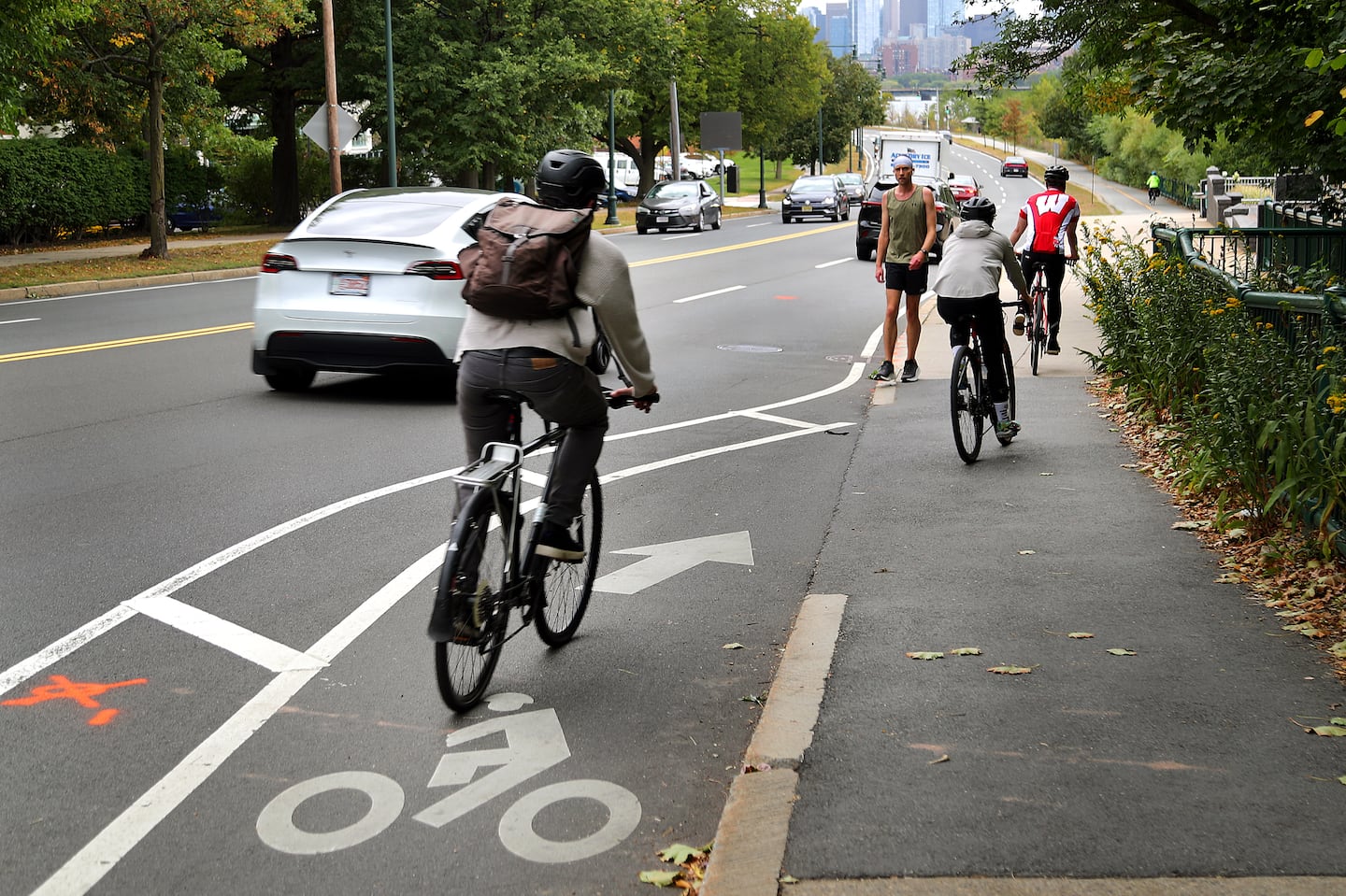 Cyclists on Memorial Drive eastbound near the BU Bridge, where the designated bike lane ends at a sidewalk.