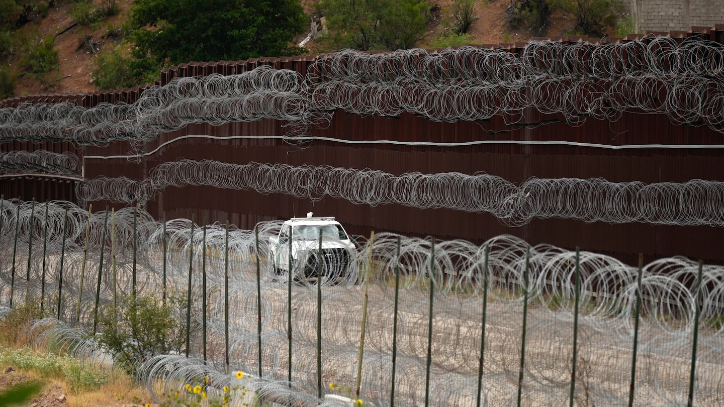 A vehicle drove along the US side of the US-Mexico border wall in Nogales, Ariz., in June.