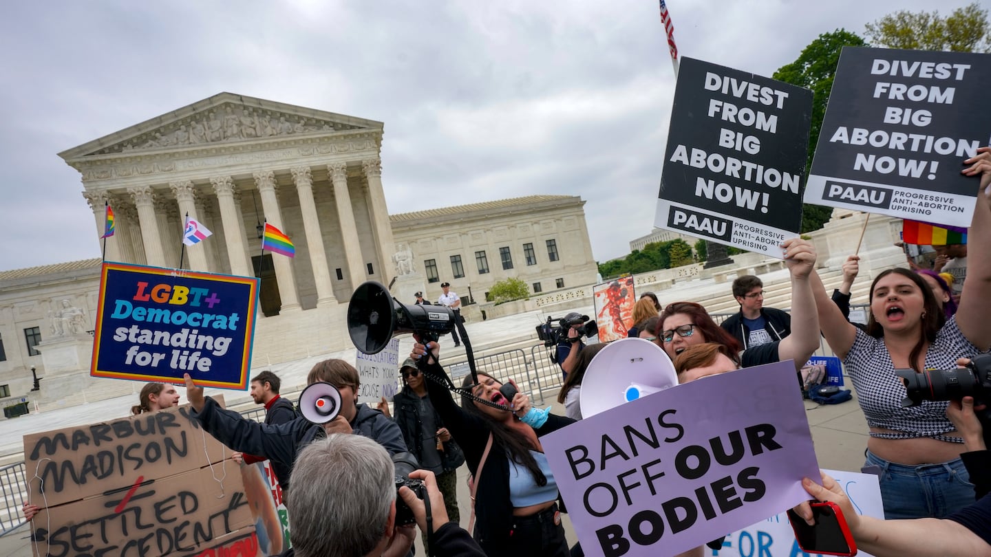 Antiabortion protesters use bullhorns to counter a gathering of mostly abortion rights advocates in front of the US Supreme Court on May 3, 2022.