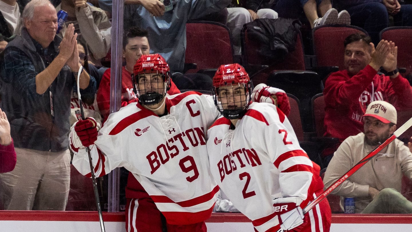 Boston University's Ryan Greene (left) celebrated one of his two goals with teammate Gavin McCarthy in Saturday's 5-2 win over Holy Cross.