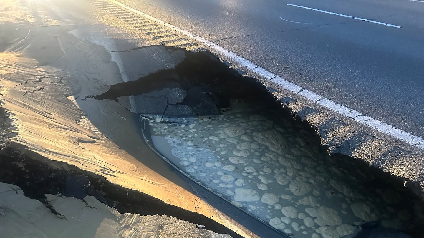 A large sinkhole on I-495 South just after Exit 106 was the result of a water main break, according to State Police.