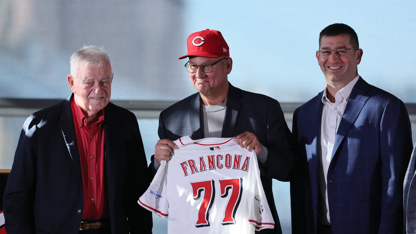 Terry Francona meets the media in Cincinnati on Monday beside Reds principal owner Robert H. Castellini and president of baseball operations Nick Krall.