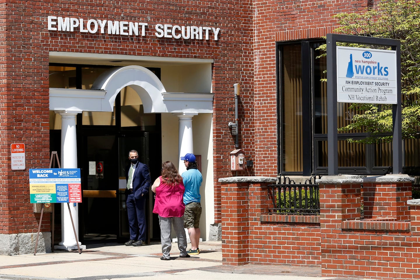 Job seekers line up outside the New Hampshire Works employment security job center on May 10, 2021, in Manchester, N.H.