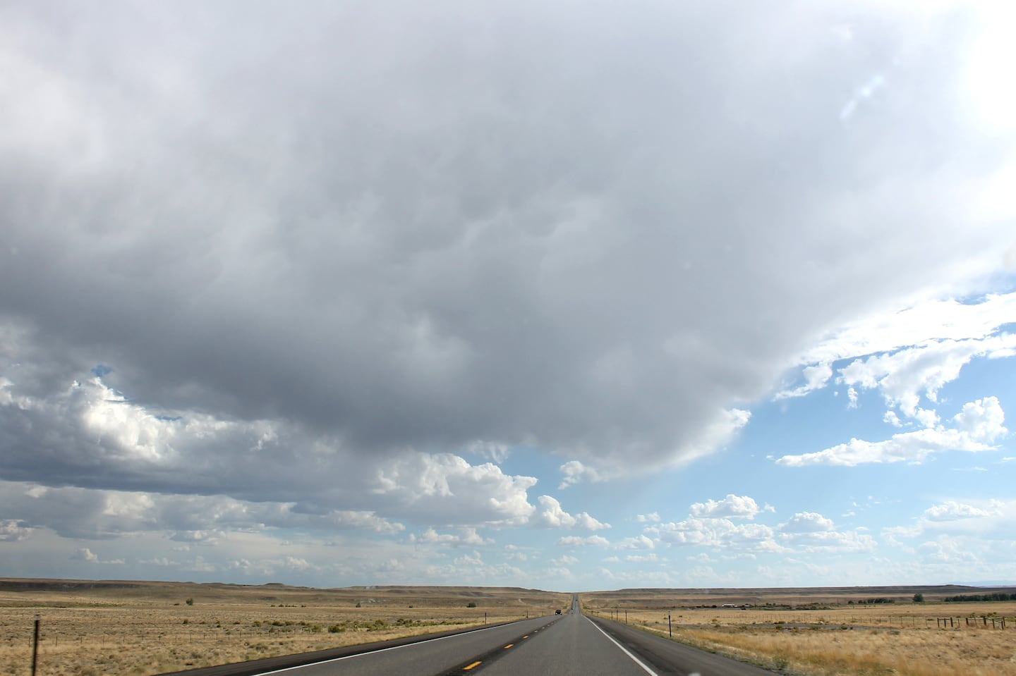 An afternoon storm rolls over the plains on US Route 20 in Wyoming.