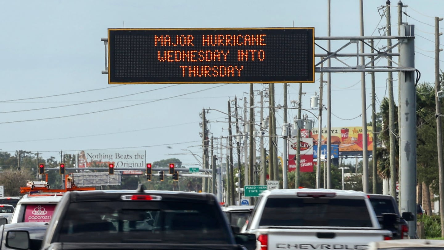 Highway signage announces the impending arrival of Hurricane Milton and the evacuation zones, Oct. 8, in Port Richey, Fla.