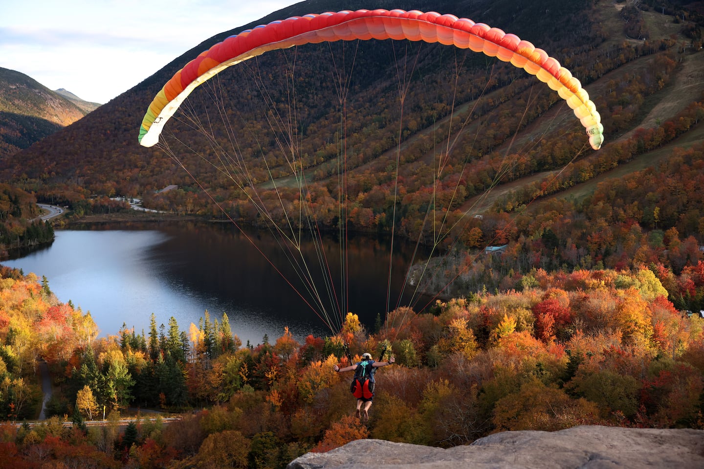 Matthew Bolarinho launches off the top of Artist’s Bluff in Franconia, N.H., on Tuesday.