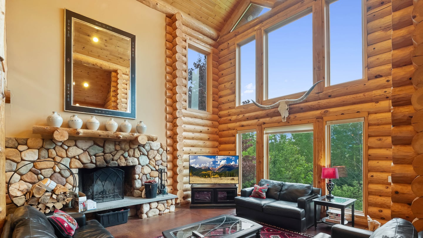 The living room features a wall of windows.