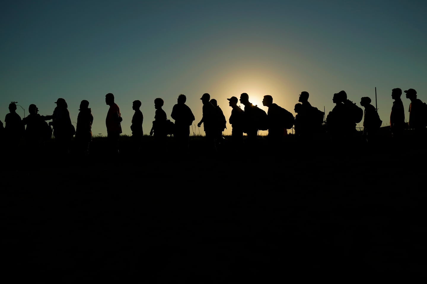 Migrants who crossed the Rio Grande and entered the United States from Mexico were lined up for processing by US Customs and Border Protection, Sept. 23, 2023, in Eagle Pass, Texas.