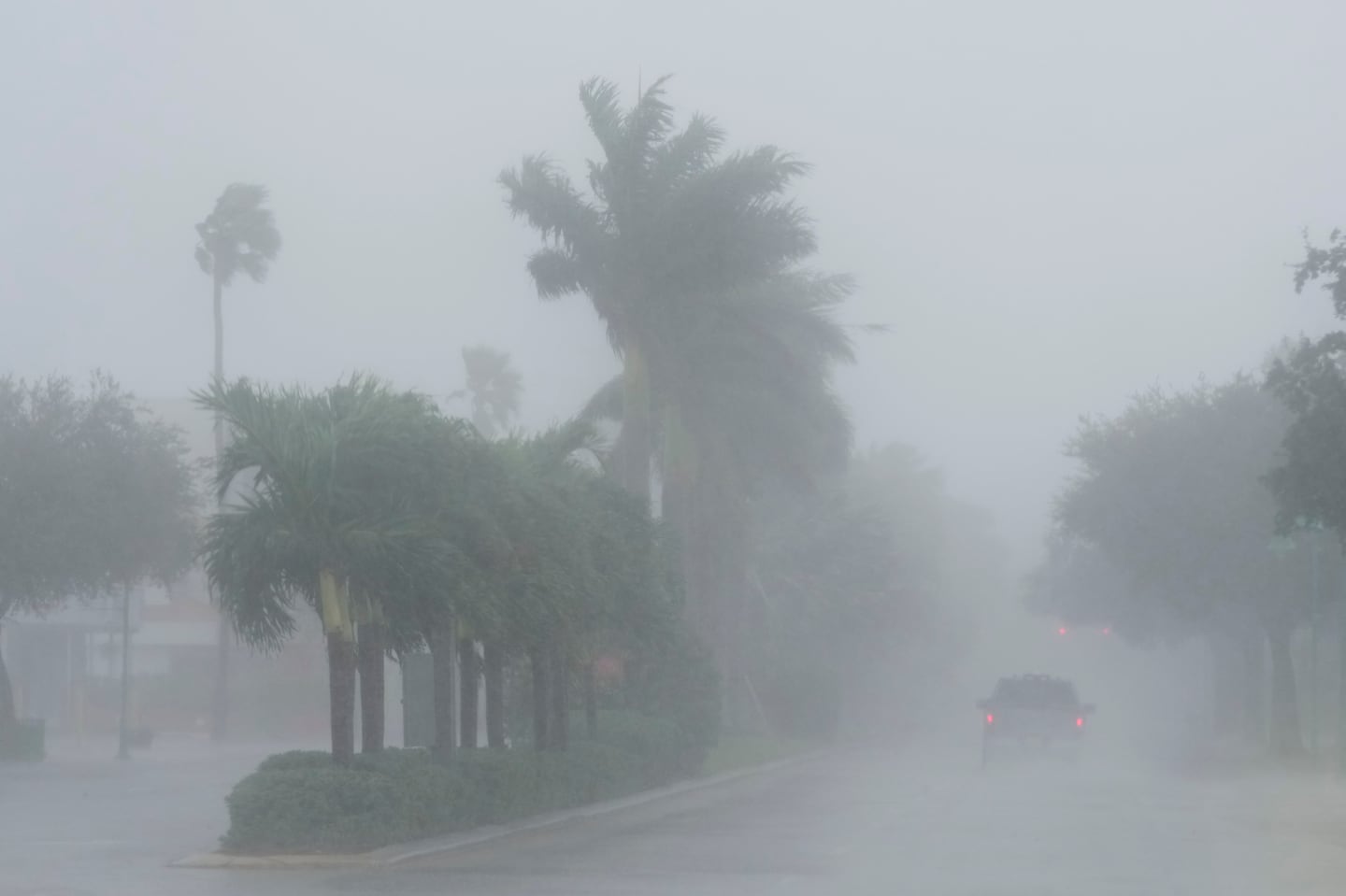 A Lee County sheriff's officer patrols the streets of Cape Coral, Fla., as heavy rain falls ahead of Hurricane Milton, Wednesday.