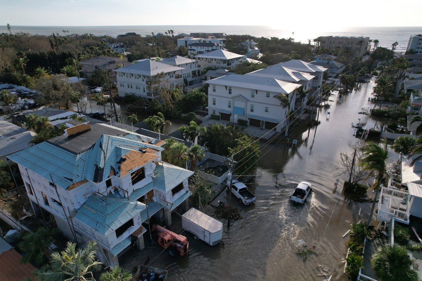 A truck drives down a flooded street in Siesta Key, Fla., following the passage of Hurricane Milton, on Oct. 10.