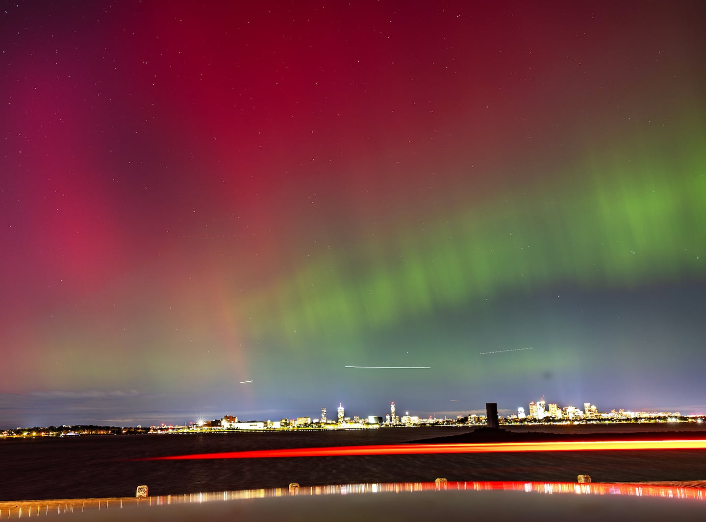 The northern lights dance over the Boston skyline at 10:30 p.m. Thursday as seen from Quincy.