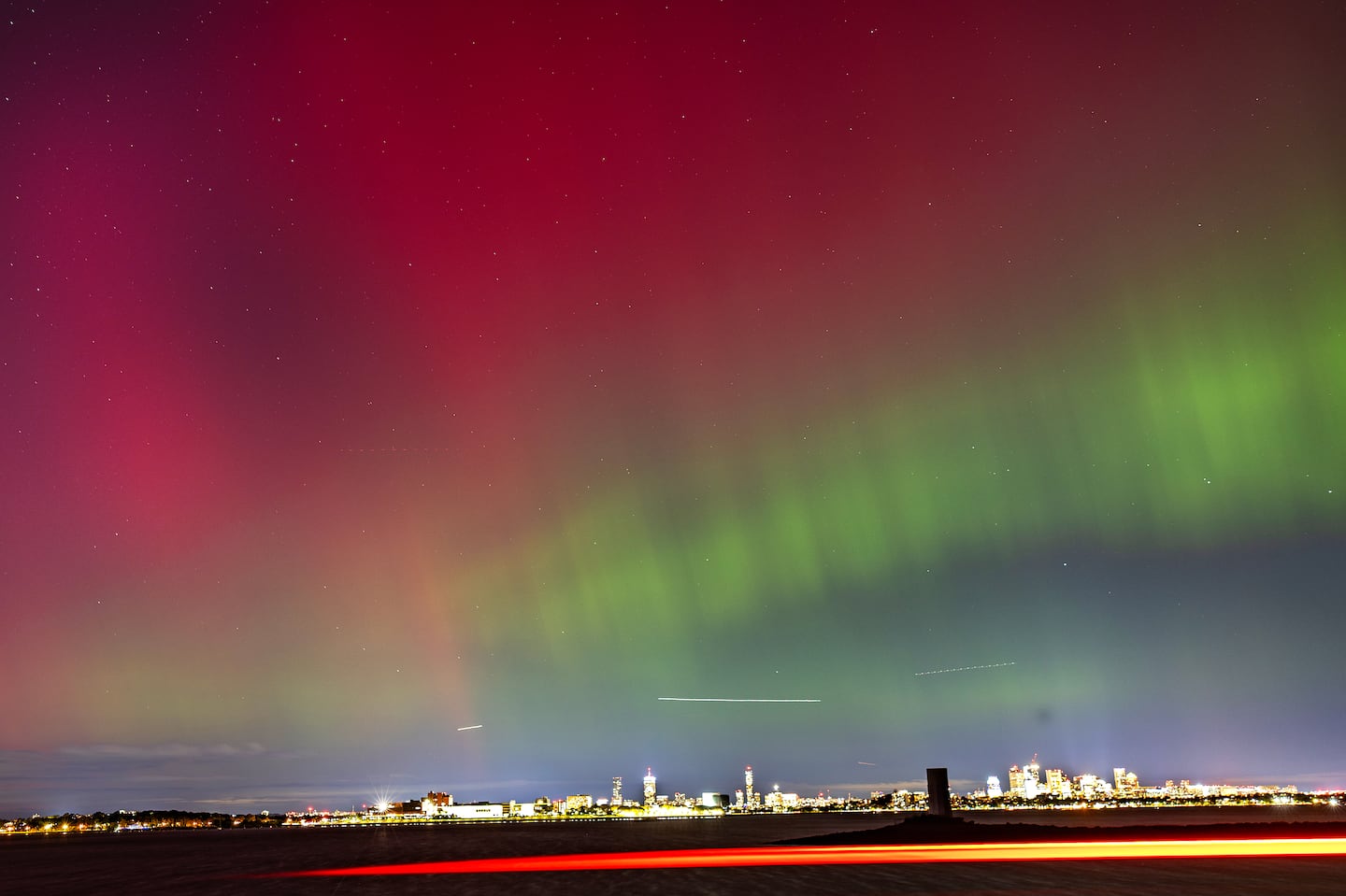 The northern lights were seen over the Boston skyline Thursday night from the Squantum section of Quincy..