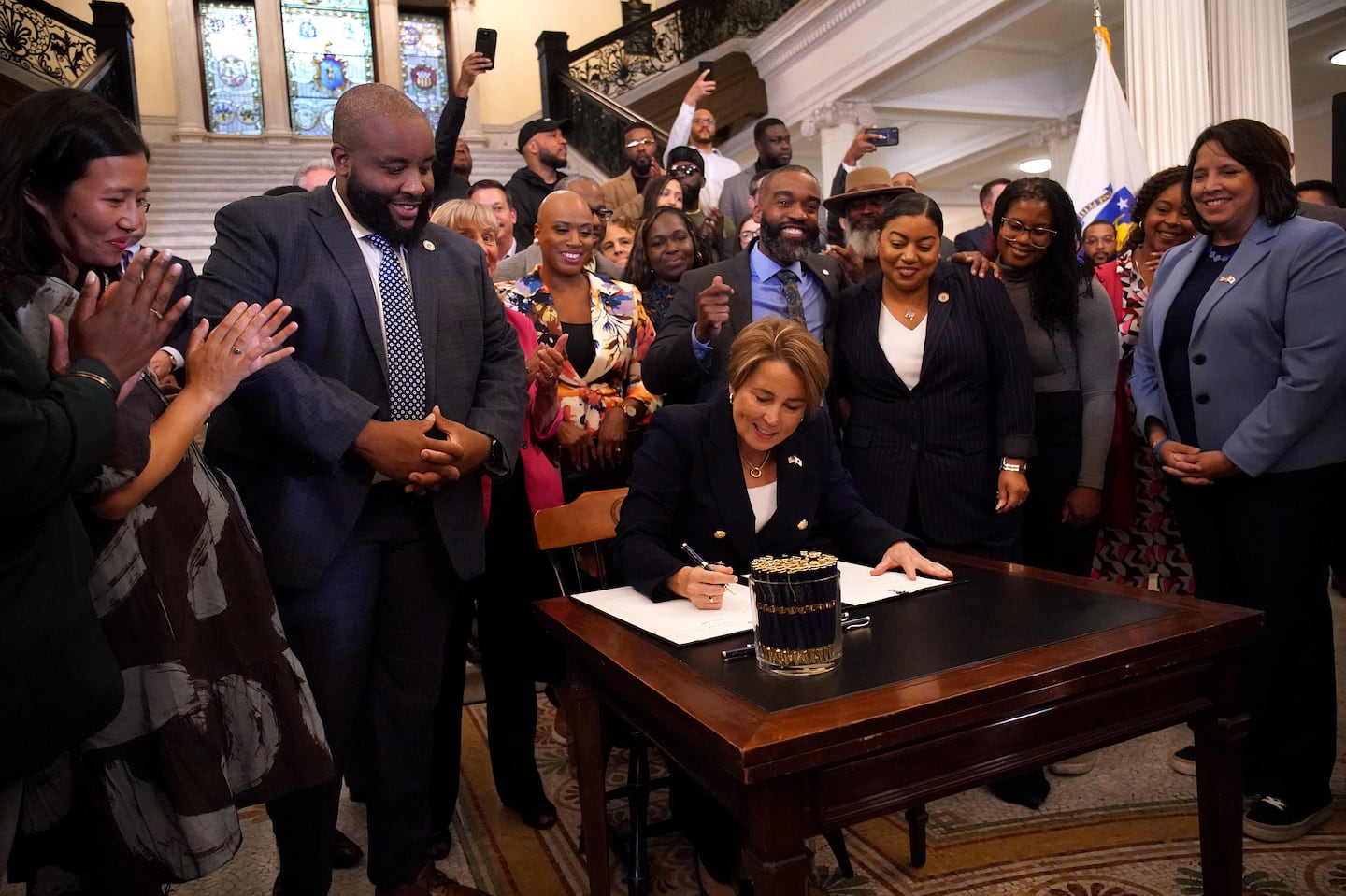 Maura Healey signing a bill into law.