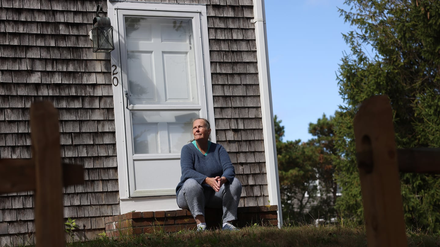 Joanne Skokan posed for a portrait on the front steps of her Nantucket home on Toms Way. After discovering their wells were contaminated with PFAS, Skokan joined her neighbors in a class action lawsuit against the companies that manufactured the chemicals.