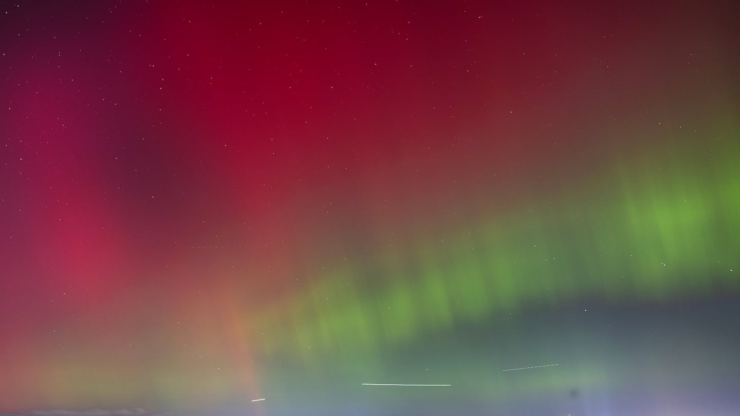 The northern lights were seen over the Boston skyline Thursday night from the Squantum section of Quincy..