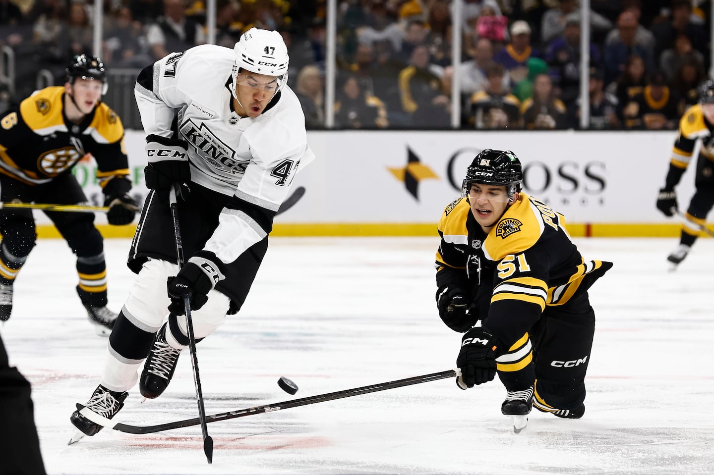 Matt Poitras (right) knocked the puck off the stick of Andre Lee during the second period of the Bruins' win over the Kings at TD Garden.