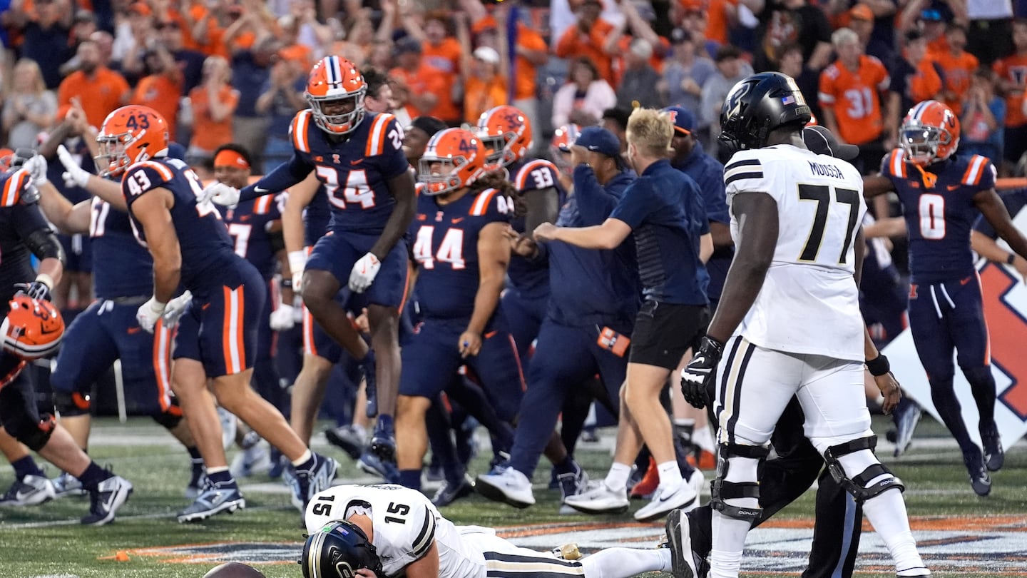 Purdue quarterback Ryan Browne lays on the ground after being sacked on a two-point try, giving Illinois the overtime victory Saturday in Champaign, Ill.