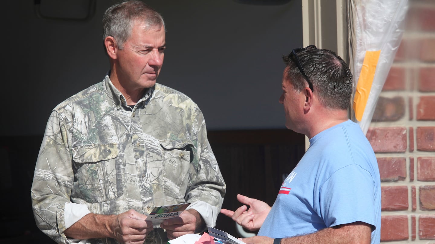 Bob Schmidt, right, a Republican voter, talks to state Rep. Jesse Borjon, left, R-Topeka, outside the garage of Schmidt’s home, on Oct. 5, in Kansas.