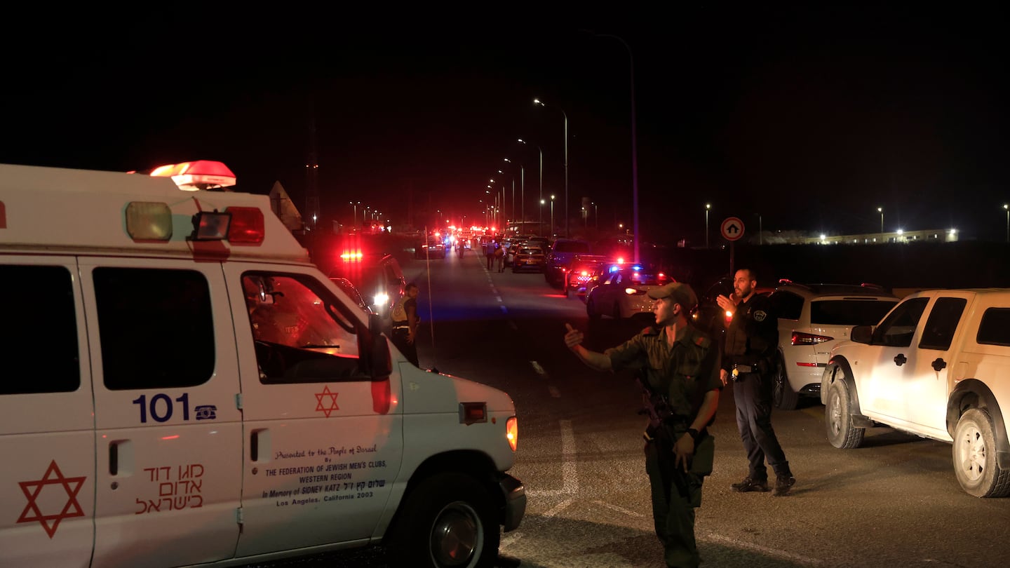 Emergency services personnel attend the scene of a drone strike on Oct. 13 in Binyamina, Israel.