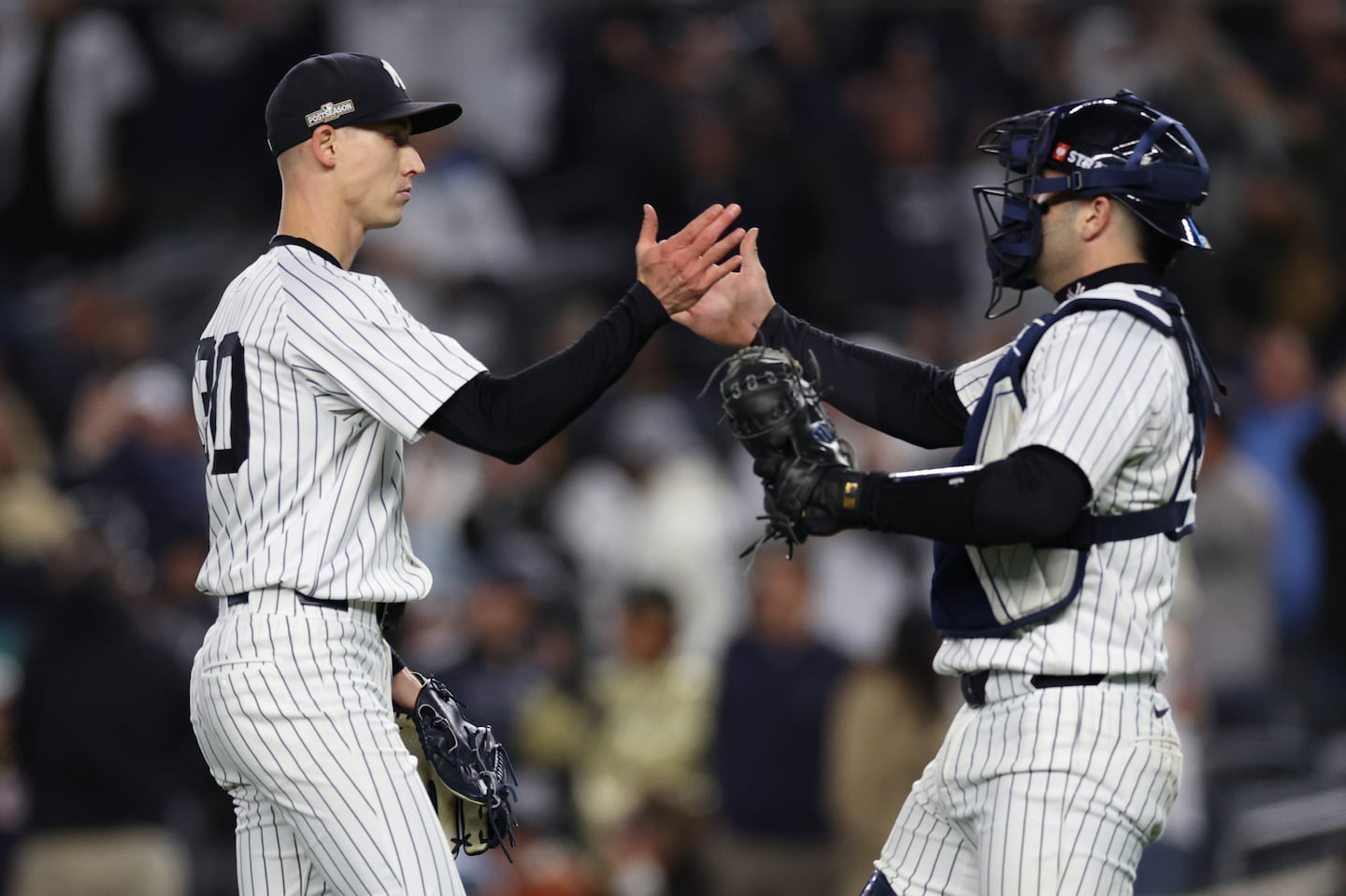 The Yankees' Luke Weaver was congratulated by catcher Austin Wells after getting the save in Game 1 of the ALCS against the Guardians, his fourth of the postseason.