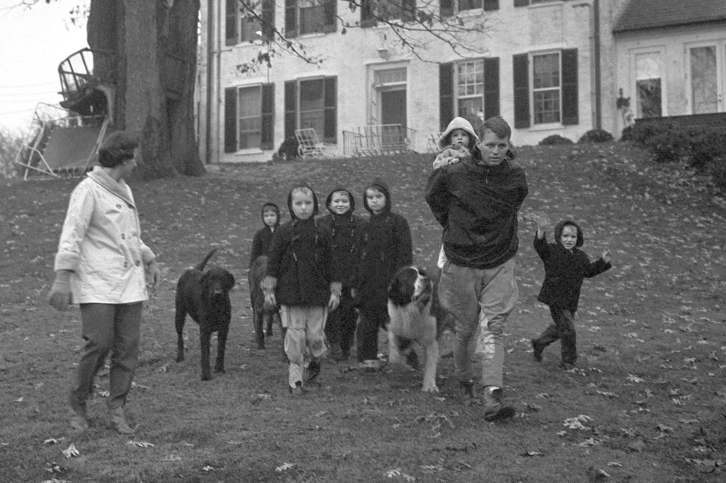 Ethel Kennedy with children Courtney, 3, Kathleen, 8, Joseph Patrick, 7, Bobby, 5, husband Robert F. Kennedy, with Michael, 1, on his back, and David, 4, take a walk at the Kennedy home in McLean, Va., on Dec. 30, 1959.