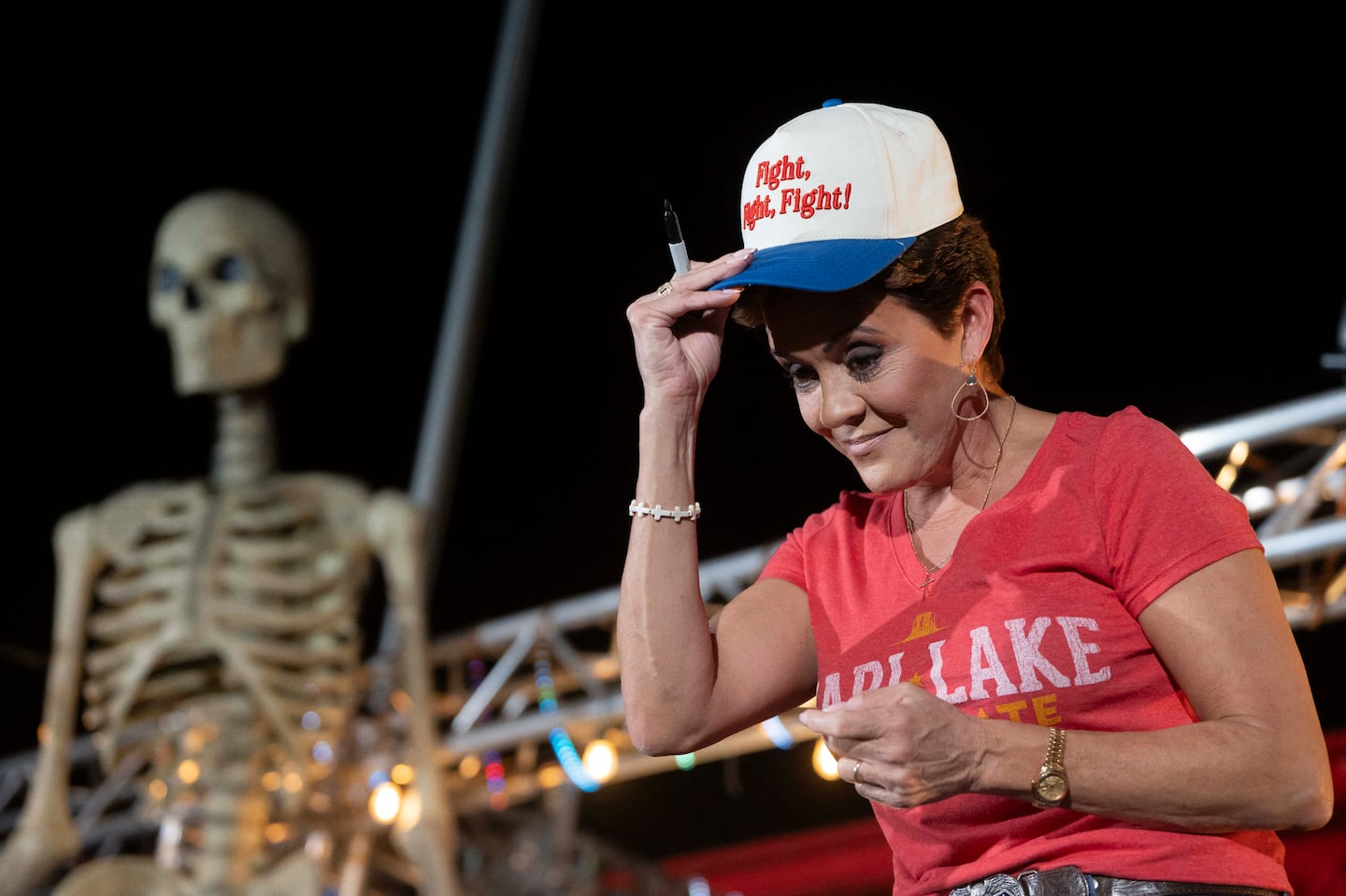 Republican Senate candidate Kari Lake of Arizona tried on a hat quoting Donald Trump's words "Fight, Fight, Fight" he spoke seconds after surviving his first assassination attempt, during a rally in Morristown, Ariz., on Oct. 5.