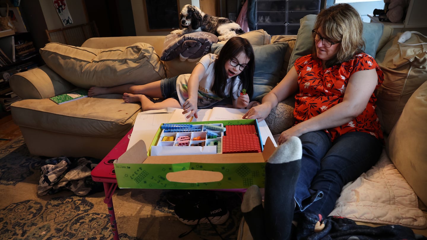 Darlene Gildersleeve, who has long covid, works on a math lesson with her daughter Abigai in 2023. Researchers hope a new study may pave the way for effective treatments for some patients with long COVID.