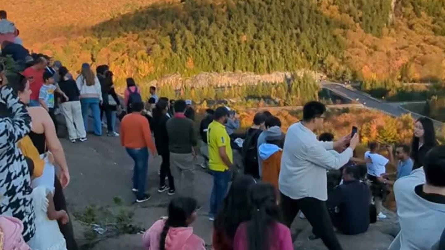 Hikers and tourists crowded together at Artist's Bluff in Franconia, N.H., on Oct. 5, 2024, trying to take in a view of the bright fall foliage.