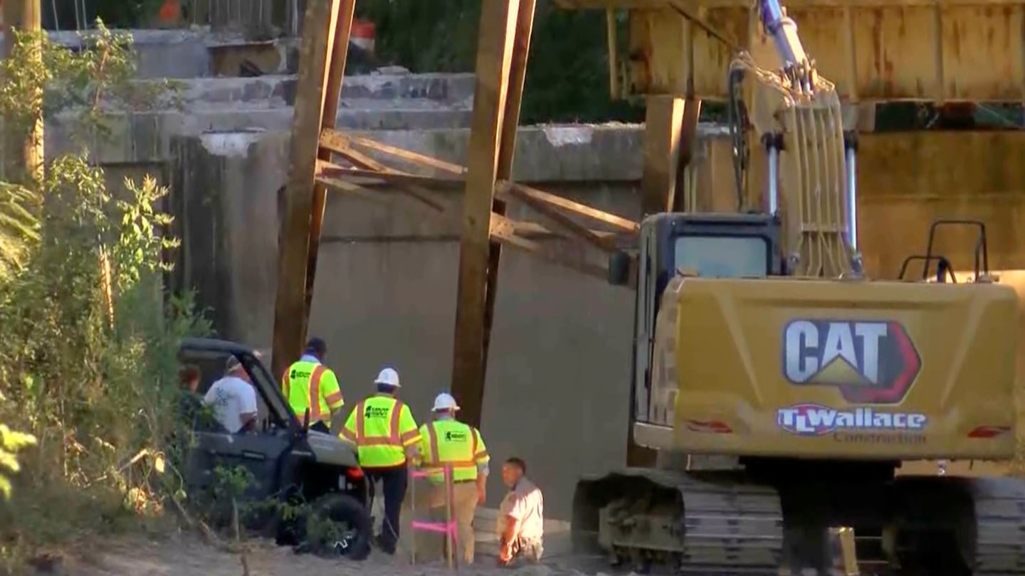 This image taken from video from WLBT shows law enforcement and Mississippi Department of Transportation workers at the scene after a bridge over the Strong River on State Route 149 in Simpson County, Miss., collapsed on Oct. 16.