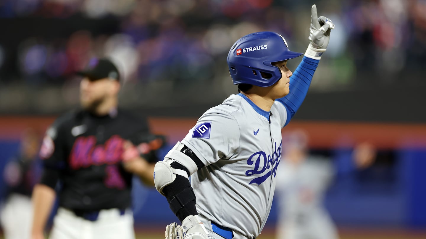 Shohei Ohtani reacts after blasting a three-run home run in the eighth inning of the Dodgers' 8-0 win over the Mets in Game 3 of the National League Championship Series.