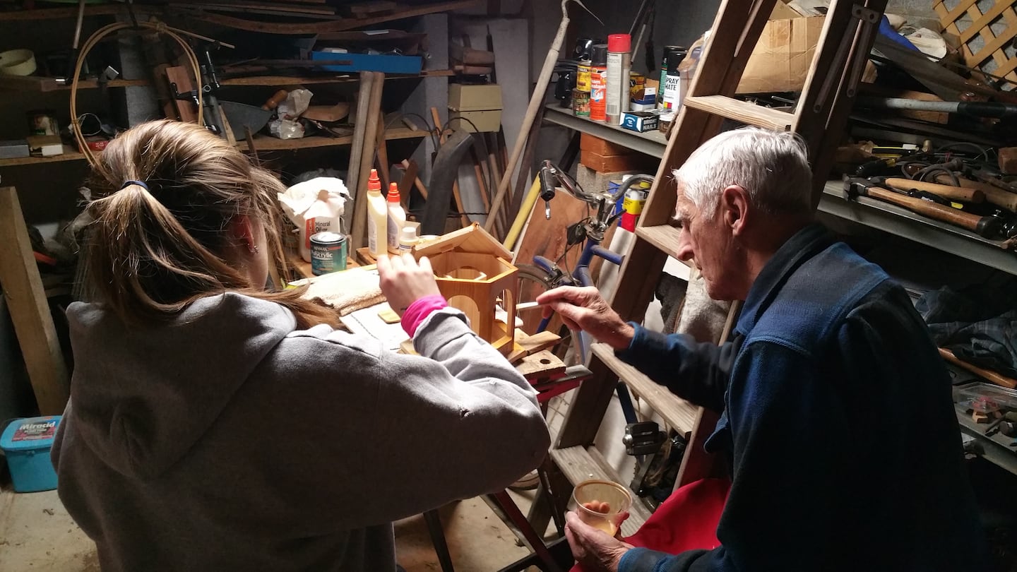 The writer's father, Glenn Selfridge, in the early stages of Alzheimer's, painted bird feeders with his granddaughter, Kate Abraham, in 2014.