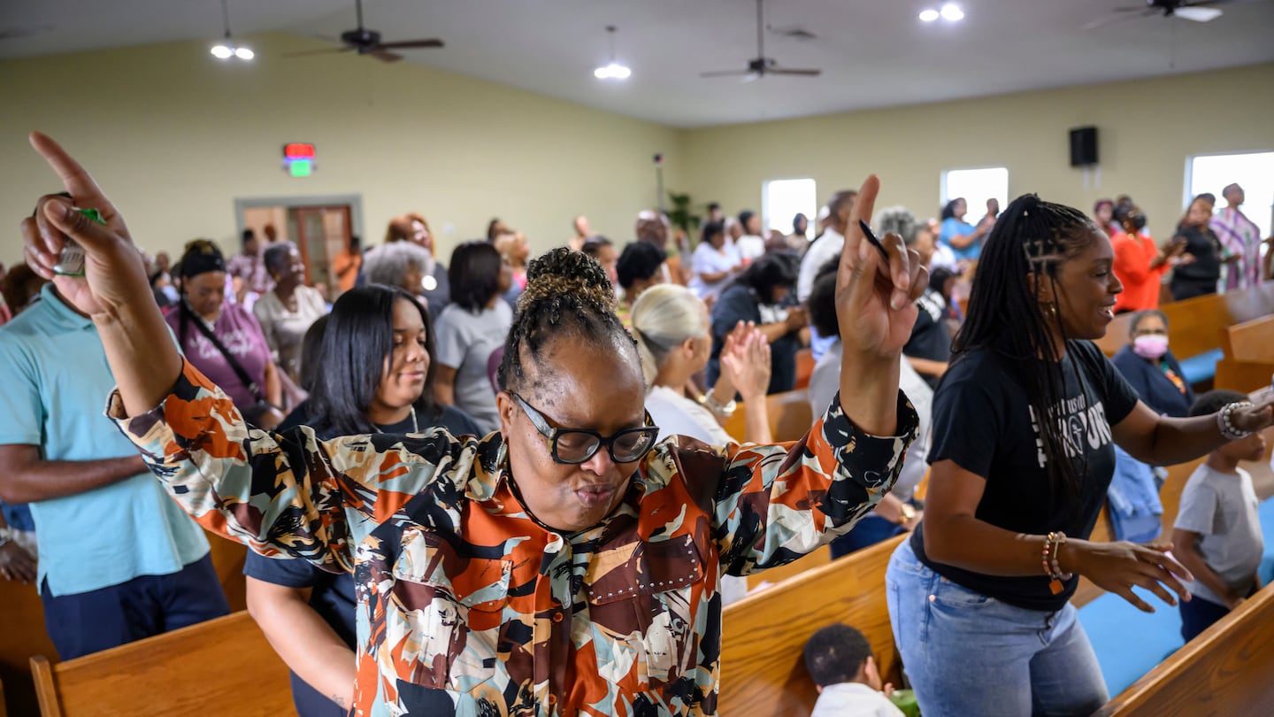 Peggy Whitfield, left, of Baltimore, attends a service at Mt. Olive Baptist Church, on Aug. 18, in Turner Station, Md.