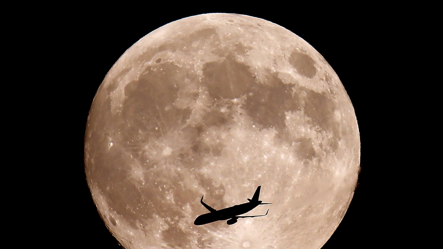 A near full Hunters Moon, also a supermoon rises Wednesday evening over Halifax as a jet flys by. The full moon is Thursday morning at 7:26 am.