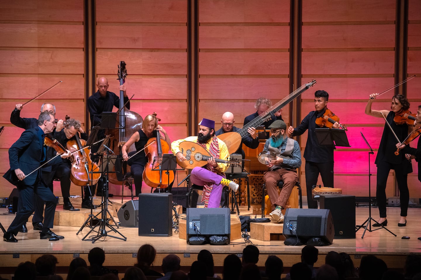 Joseph (purple hat) and James Tawadros (gray hat) performing "The Four Seasons" with the Australian Chamber Orchestra at Sydney's City Recital Hall. The ensemble brings the program to Jordan Hall Friday.