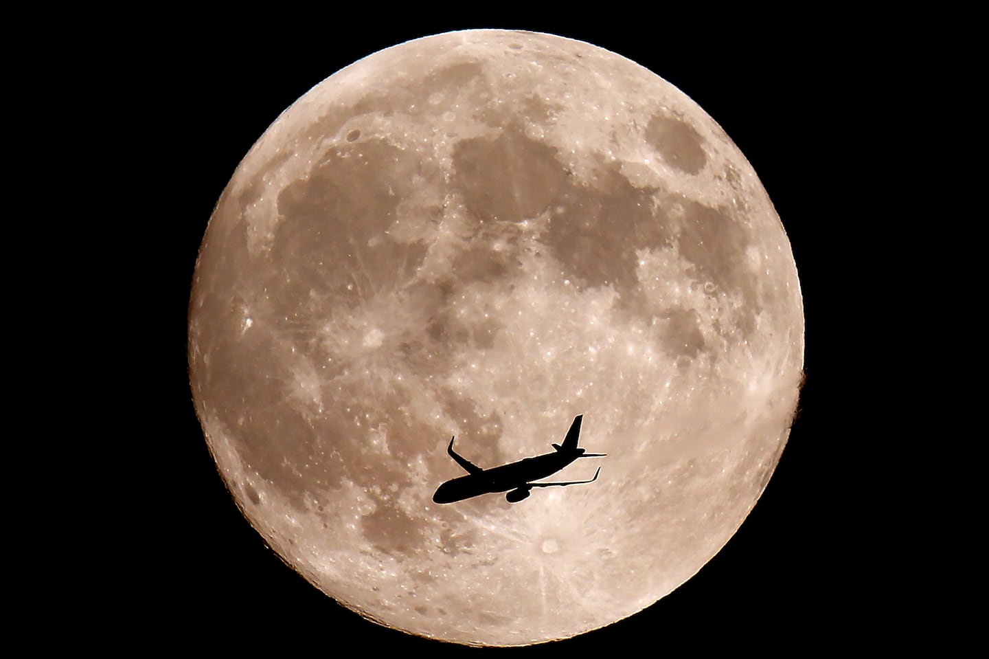 A near full Hunters Moon, also a supermoon rises Wednesday evening over Halifax as a jet flys by. The full moon is Thursday morning at 7:26 am.