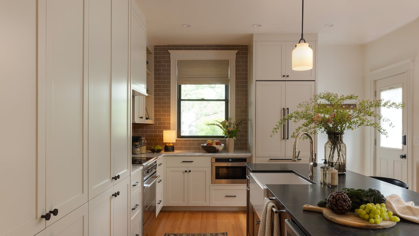 The new plan not only enlarged the kitchen (right), it let in more sunlight since the back door is half glass.