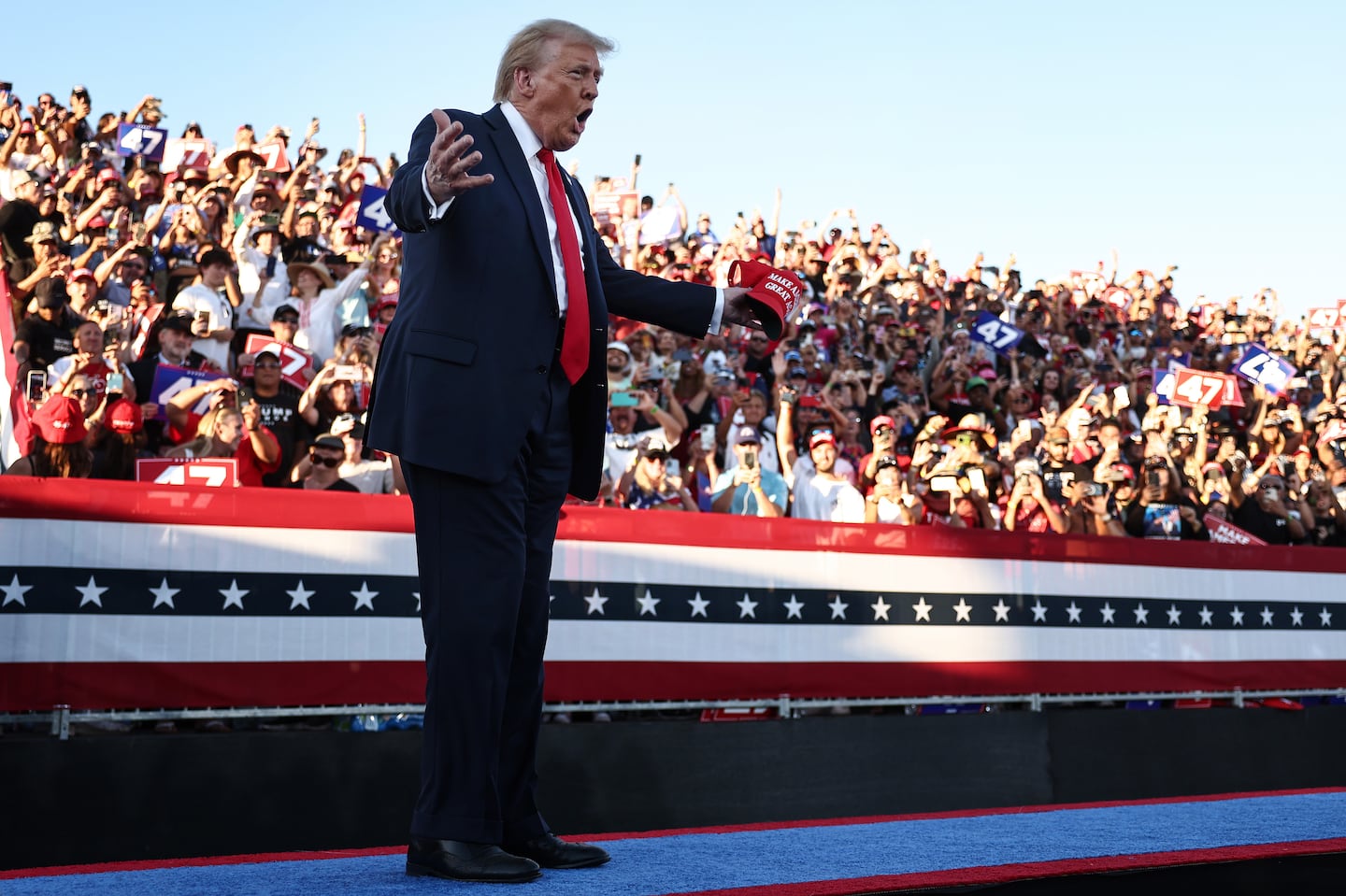 Former president Donald Trump gestures as he walks onstage for a campaign rally on Oct. 12, 2024 in Coachella, Calif.