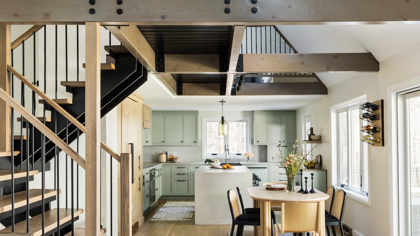 Designer Daniela Forte had to navigate multiple ceiling heights in the combined kitchen and dining area, and ensure that the various wood species of the cabinetry, floor, stair treads, and beams didn’t vary too much.