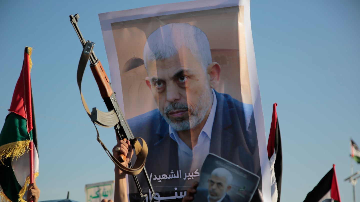 Houthi supporters raise a poster of Hamas leader Yahya Sinwar, who killed by Israeli troops in Gaza, during an anti-Israel rally in Sanaa, Yemen, Friday, Oct. 18, 2024.