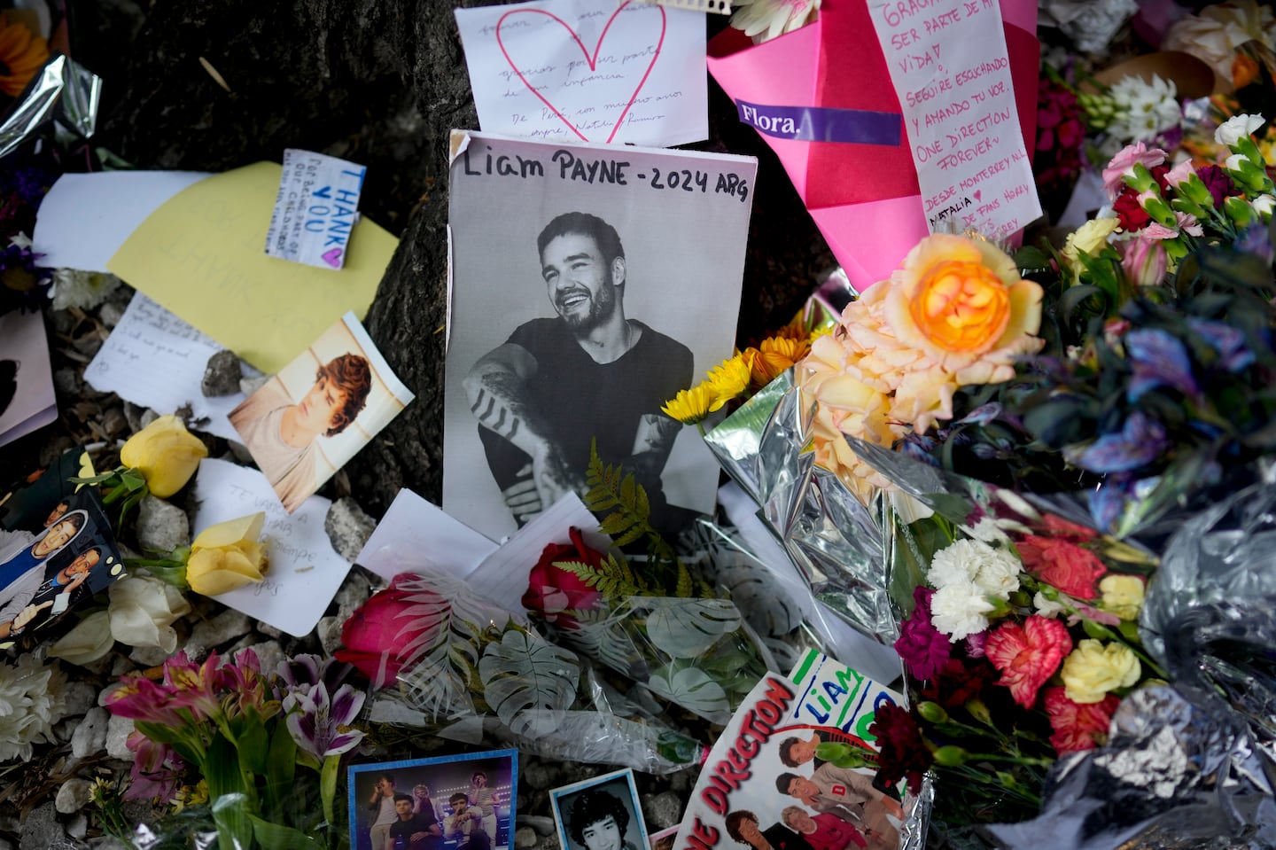 A picture of former One Direction singer Liam Payne was surrounded by flowers and candles as fans gathered outside the hotel where he was found dead in Buenos Aires, Argentina.