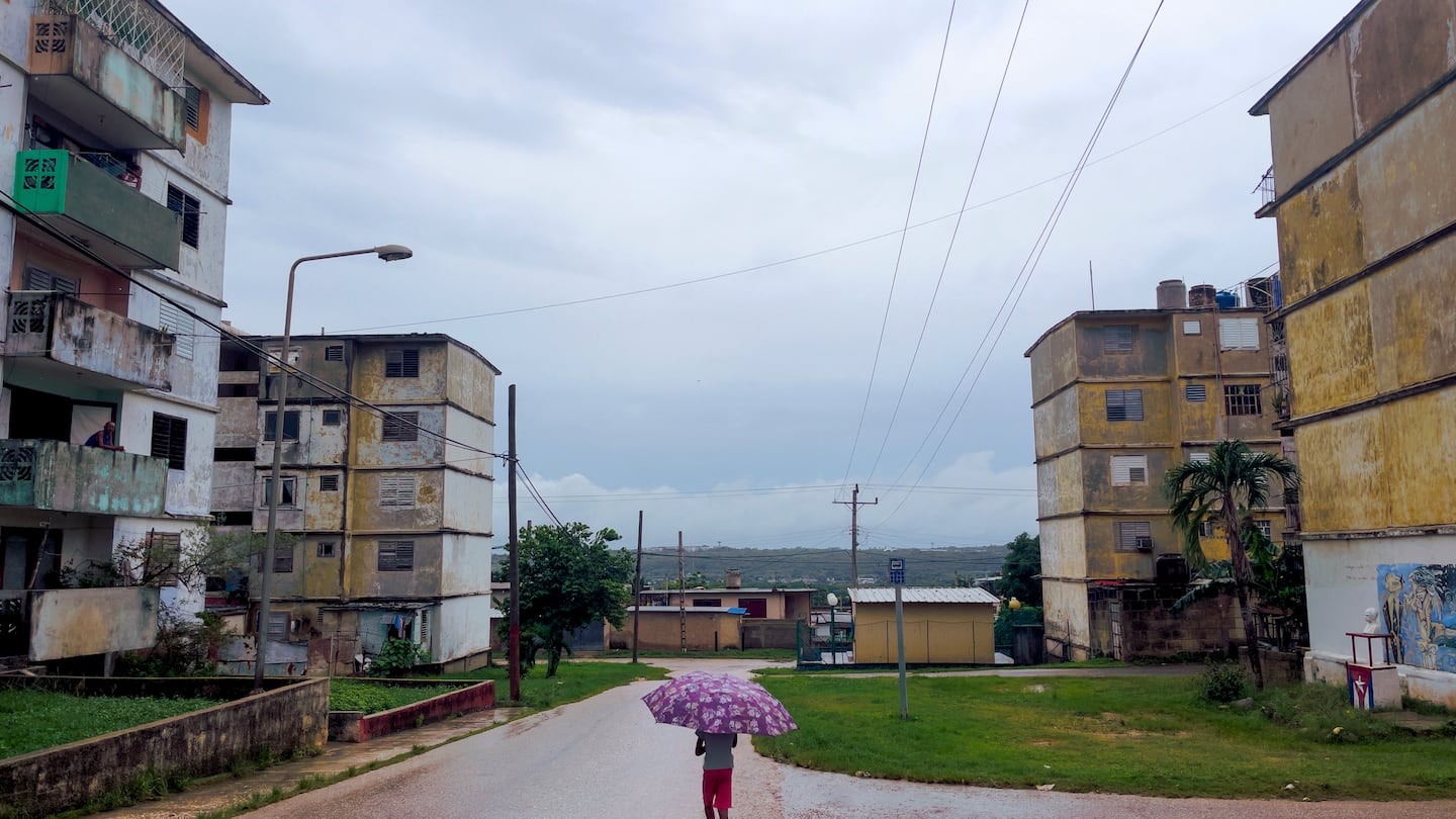 A child walked carrying an umbrella in Matanzas, Cuba, on Friday during a nationwide blackout caused by a grid failure.