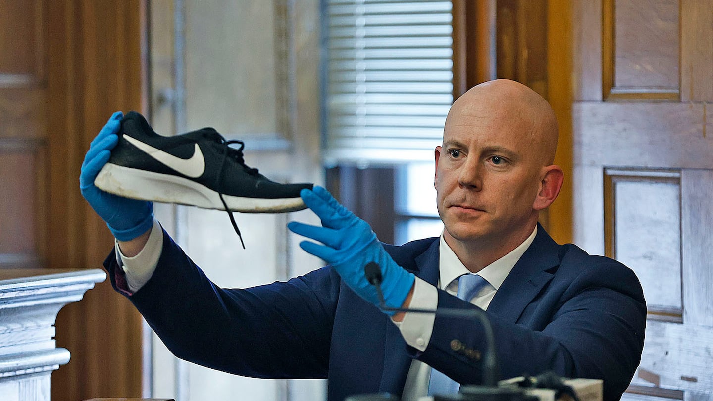 Massachusetts State Police Detective Lt. Brian Tully on the witness stand in the Karen Read murder trial in June. He is showing a sneaker found at Fairview Road that matches one taken off John O'Keefe's body at a hospital.