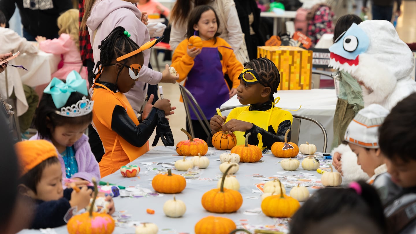 Children decorate pumpkins at PruBoo.