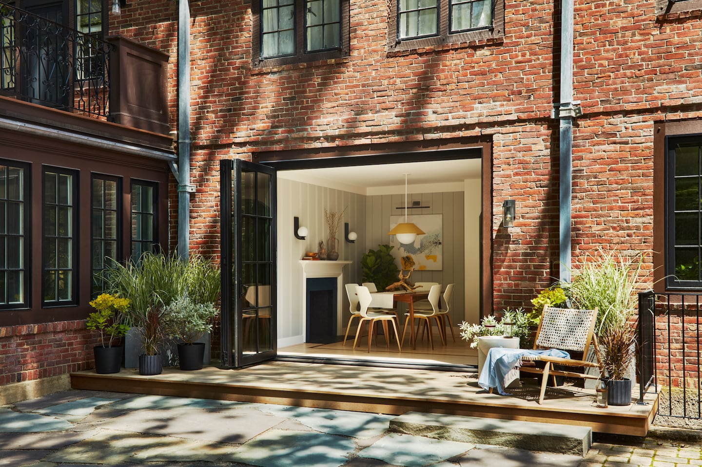 A three-panel door with a retractable screen replaced two windows, opening the reworked rooms to the backyard.