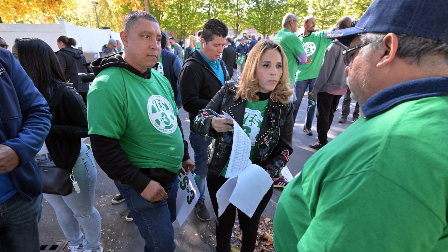 Magaly Roasario of Methuen helped organize fellow ride-hailing drivers as they prepared to canvass in Roxbury in favor of Question 3, which would allow ride-hailing drivers to unionize.