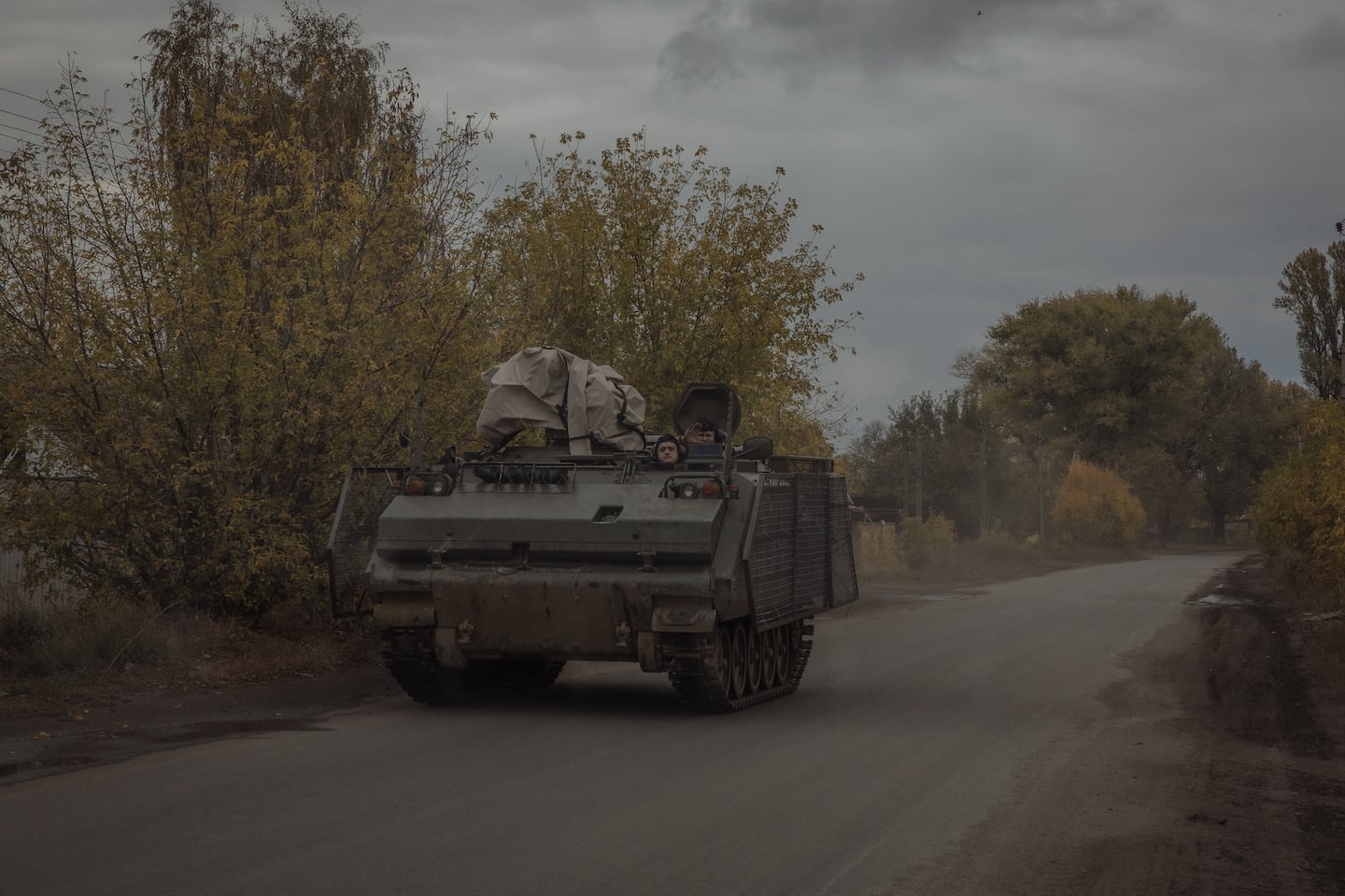 Ukrainian servicemen ride an armoured military vehicle on a road in the Donetsk region, on Oct. 16.