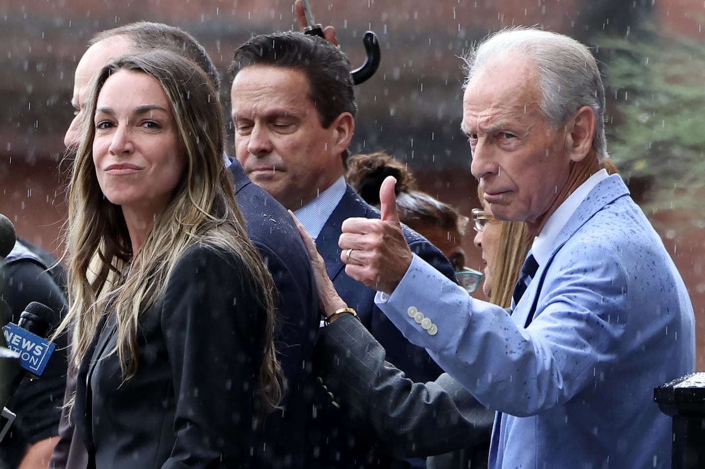 Karen Read (left) looked out as her father, William Read, gave a thumbs up outside of Norfolk County Superior Court as they reacted to news that a mistrial was declared in her trial. She is set to be retried in January.